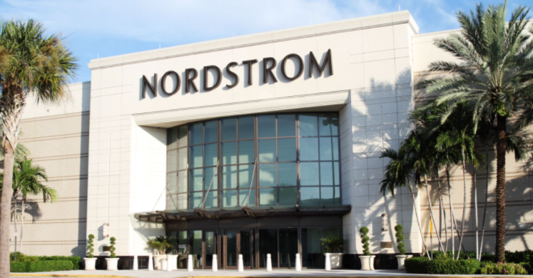 A guest is assisted by staff during the grand opening of Nordstrom